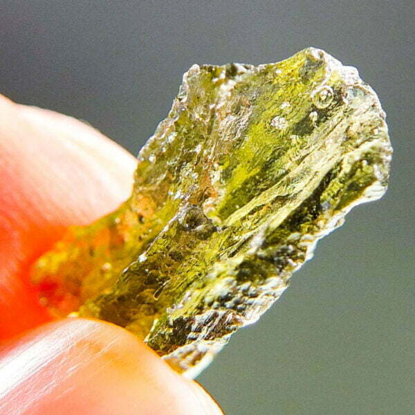 Moldavite with brown color and imprint of bubble